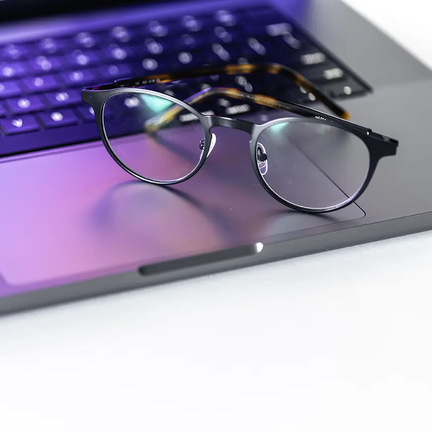 Blue light glasses on a laptop by pvproductions on Freepik